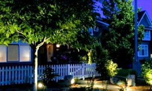 house lit up with picket fence